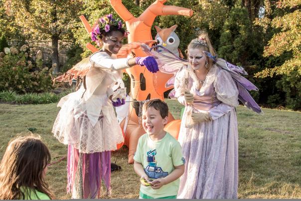 Halloween characters and trick-or-treaters at Spooky Springs event.