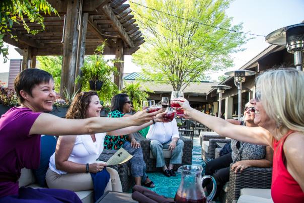 Promotional photo for Sandy Springs Restaurant Week has a group of friends drinking wine outside Under the Corktree
