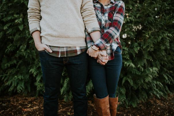 Couple holding hands at the Christmas tree farm