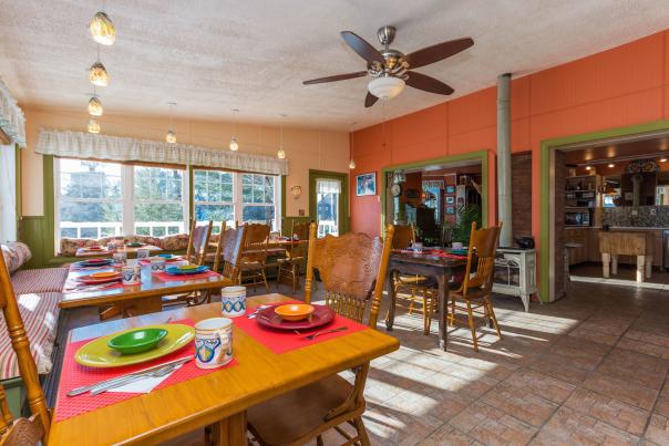 Interior shot of Saratoga Farmstead Bed & Breakfast's dining area with pops of orange, red, yellow, green and pink