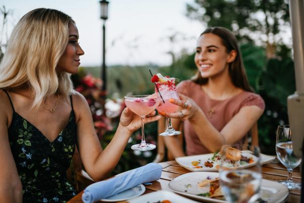 Two ladies toasting pink cocktails at Prime at Saratoga National