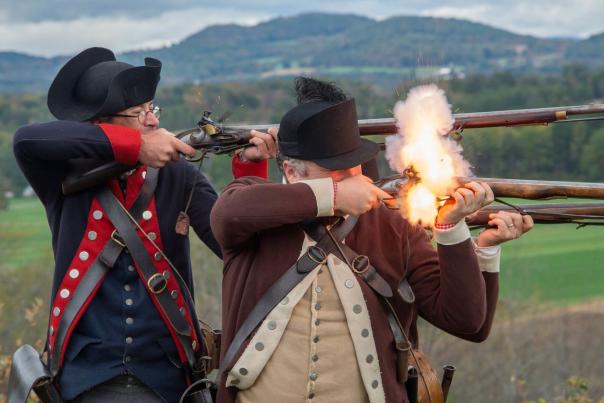 two men firing muskets