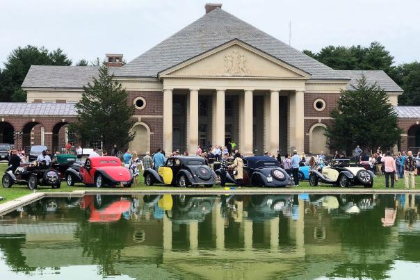 Bugattis displayed and reflected around Saratoga reflecting pool