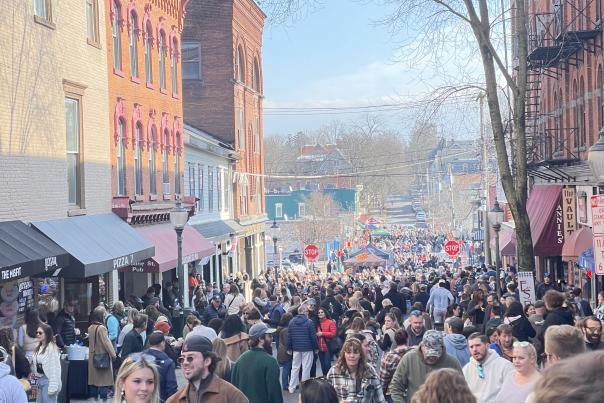 people in a crowd on Caroline Street in downtown Saratoga Springs