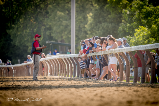 people standing on railing at Oklahoma Training Track