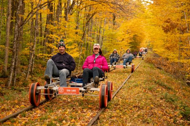 people trail biking in autumn foliage