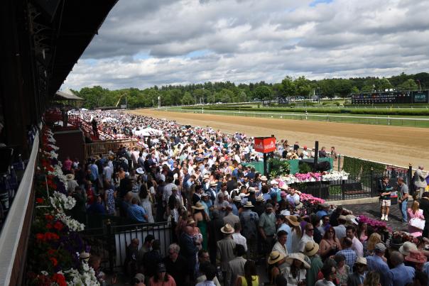 crowd watching horse racing at saratoga race course