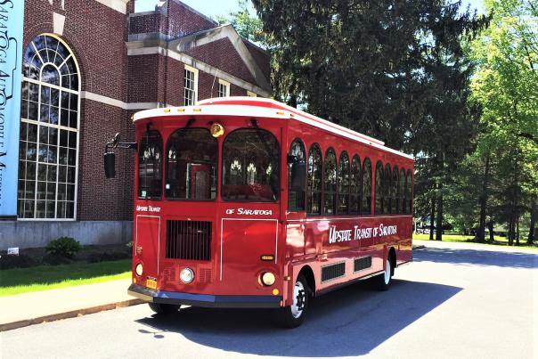 Red Saratoga Trolley in front of the Automobile museum