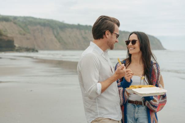 A couple eat fish and chips in Robin Hood's Bay