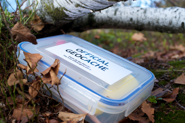 plastic tupperware container with snap lid labeled Official Geocache