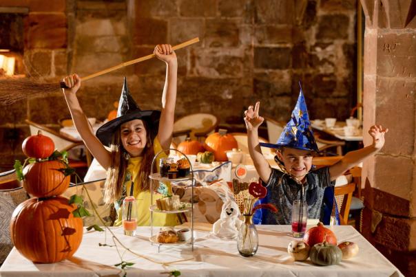 Children in Halloween Costumers enjoying afternoon tea