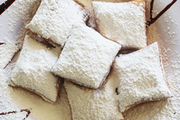 beignets with powdered sugar and chocolate