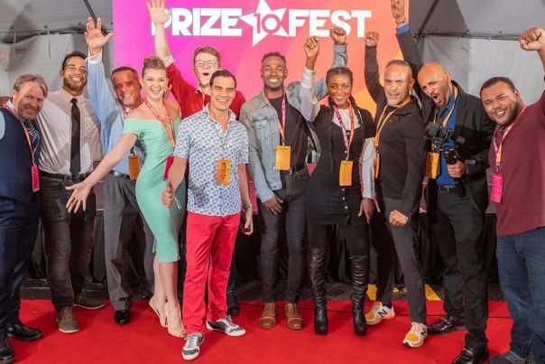 A group of eventgoers at Prize Fest in Shreveport, Louisiana posing on a red carpet.