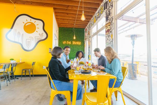Group of 5 friends eating brunch at Up For Brunch restaurant in Shreveport
