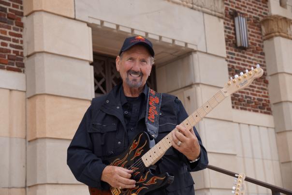 Photo of James Burton Holding Guitar In Front of Municipal Auditorium