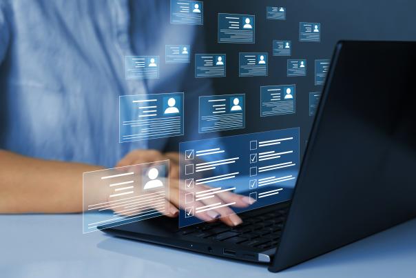A person on a laptop with persona icon bubbles around them.