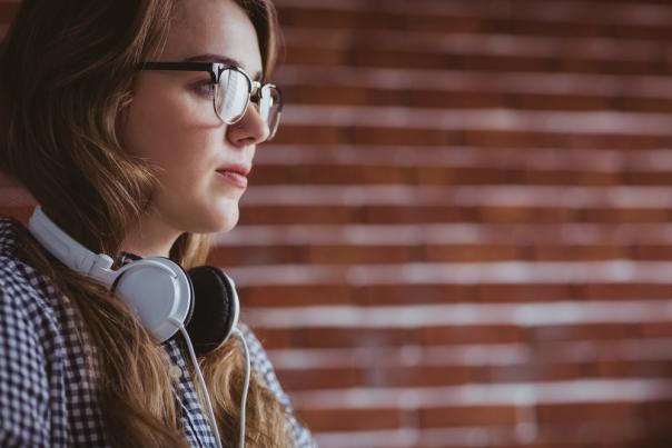 Woman with headphones around neck