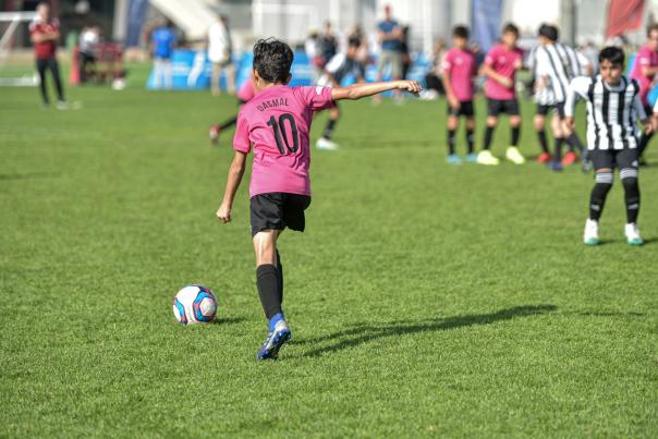 A boy gets ready to kick a soccer ball during a youth match.