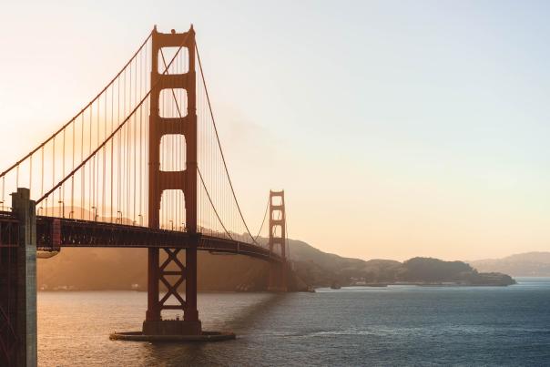 The sun sets behind the Golden Gate Bridge