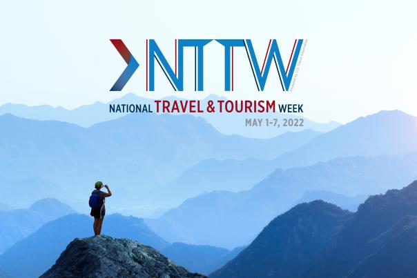 National Travel & Tourism week logo over blue mountains