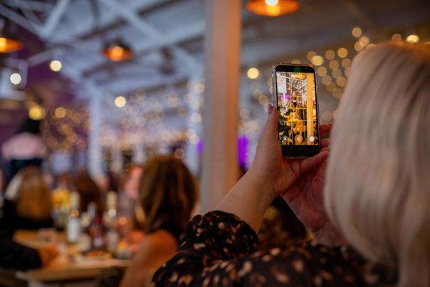 Attendee capturing the EMEA Summit 2025 Client Awards celebration, emphasizing accessibility and inclusion.