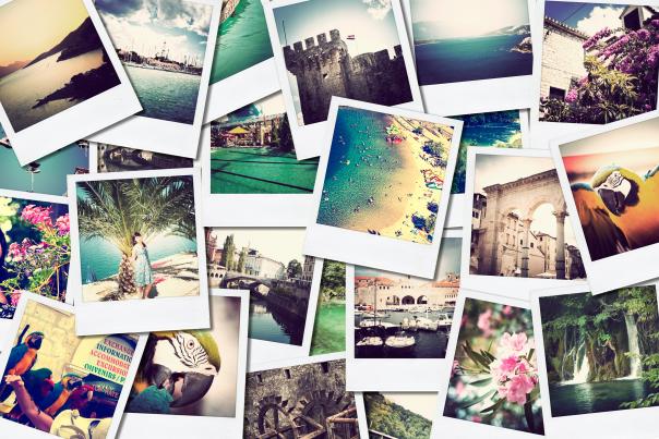 A collage of polaroid photos from travels sitting out on a table.