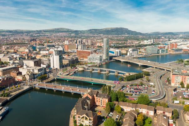An aerial photo of the river and skyline of Belfast, Ireland on a partly sunny day.
