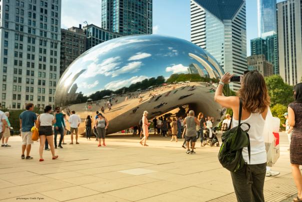Visitors looking at Anish Kapoor's The Bean in downtown Chicago