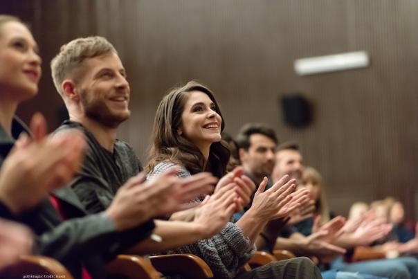 A delighted audience applauding