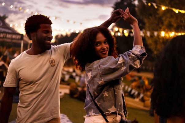 Couple dancing with lights in background