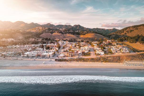 Aerial view of Avila Beach surrounded by mountains at golden hour