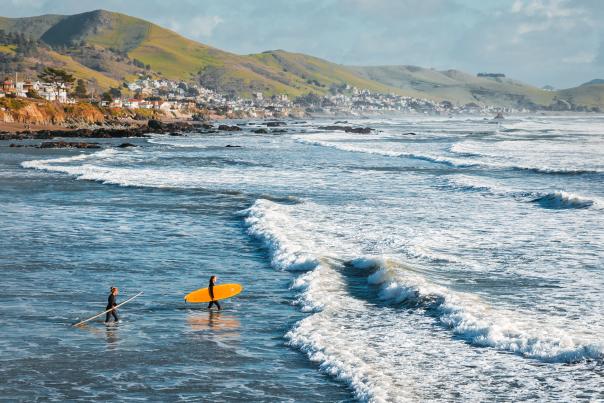 Surfers in Pismo Beach In San Luis Obispo, CA