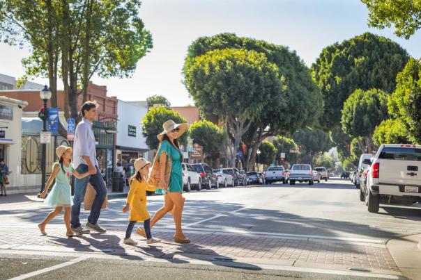 Family of four walking across a street in Downtown San Luis Obispo