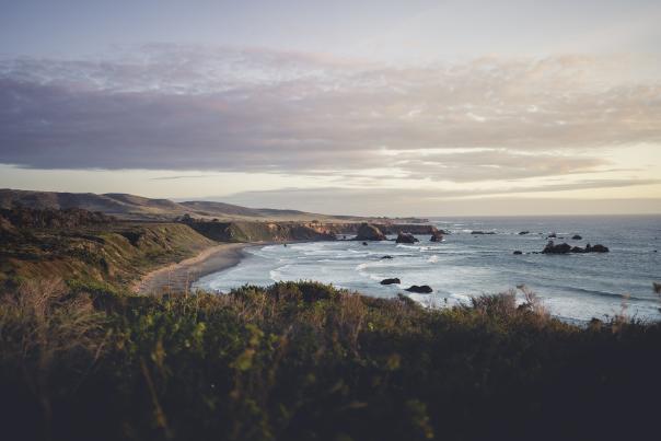 View of coast with ocean and green hills