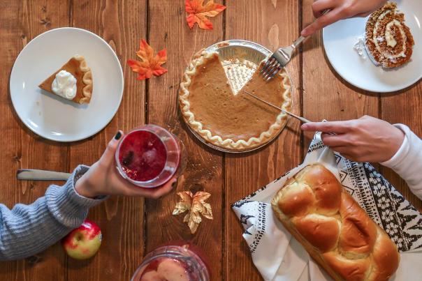 Overview of a fall holiday table with Pumpkin Pie and leaves