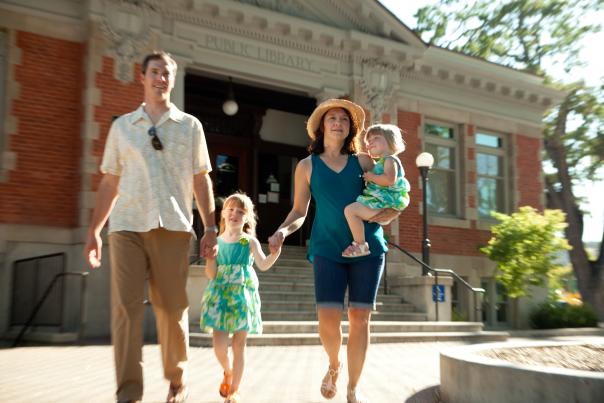 family walking in front of Carnegie library