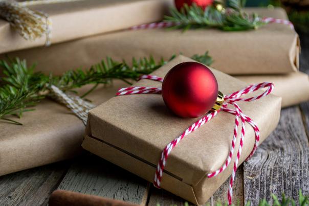 Gifts wrapped with red ornaments and greenery