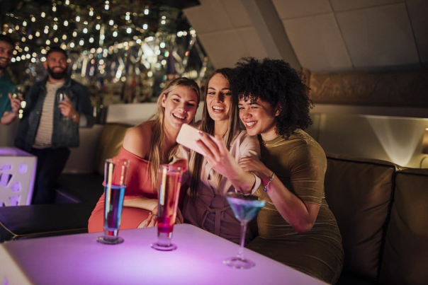 Three ladies taking a selfie in a nightclub