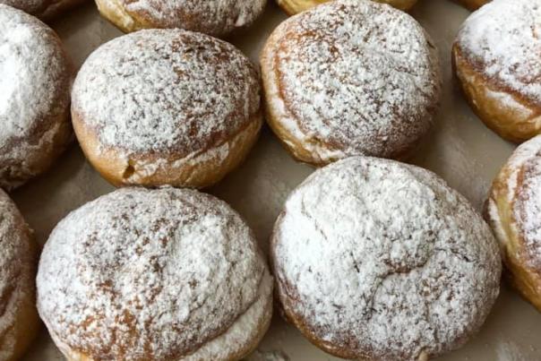 A bunch of traditional Polish filled doughnuts without a hole
