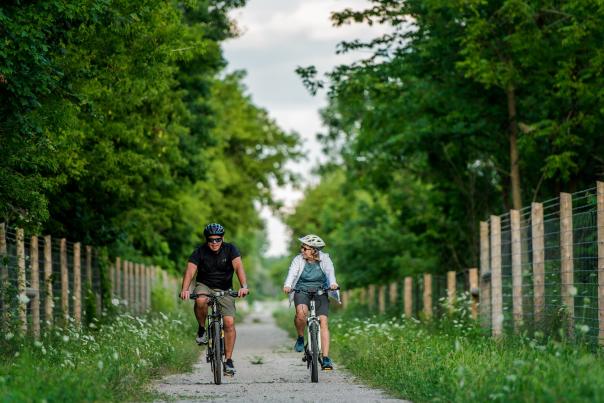 couple cycling on trail