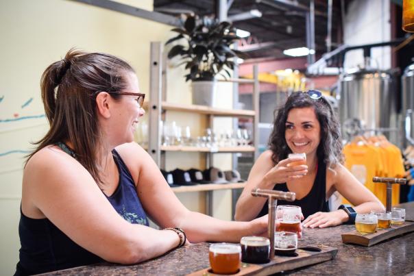 two women enjoying beers