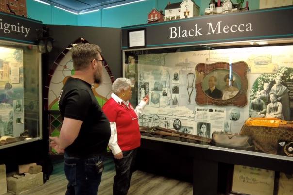 man and woman looking at historical display