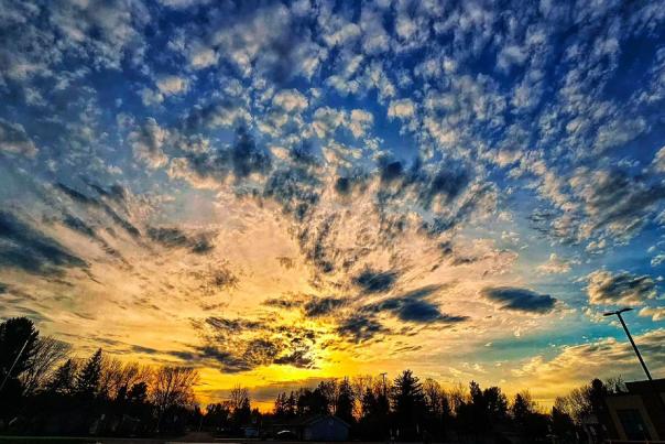 pink, orange, yellow, and blue sunset with moving clouds.