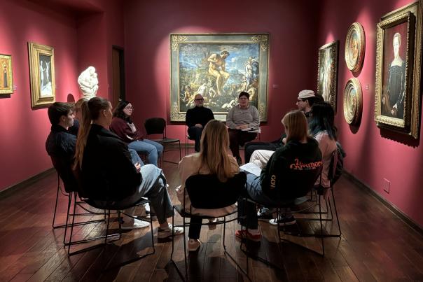 People in a gallery discussing art.