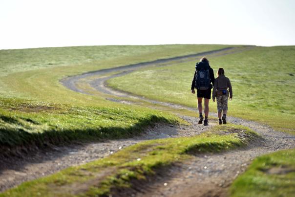 A couple walking on a track on the South Downs Way