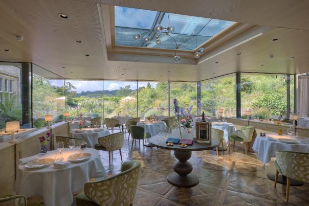The Dining Room at Michelin Star Gravetye Manor with views of the gardens
