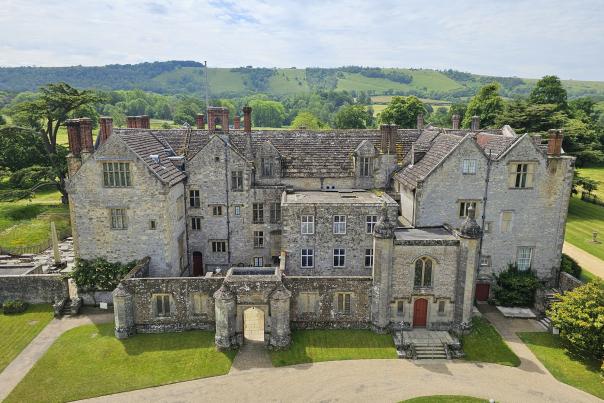 Parham House from above, a large Elizabethan house with hills in the background