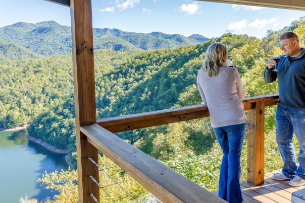 Couple on deck overlooking lake