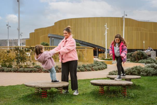 A family enjoying the coastal park at Swansea Arena