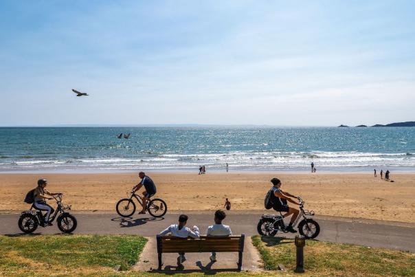 People cycling along the swansea bay coastline